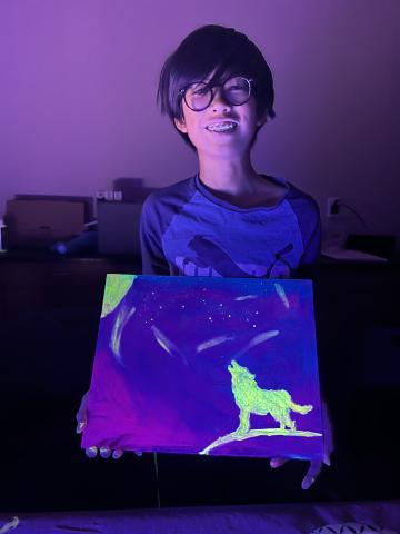 boy holding black light painting