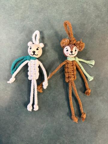2 macrame ornaments. A polar bear and a deer both wearing scarves. 